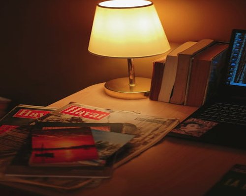 A warm desk lamp illuminating a book